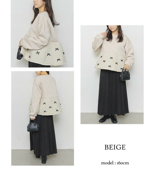 モデルが横向きにポージングしたアイボリートップスのバックスタイル