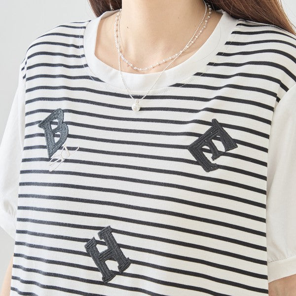 Mikonosublue Storeのアルファベット刺繍入りボーダー切り替え半袖Tシャツ。ホワイトとブラックの爽やかな配色で、立体的な刺繍が特徴のゆったりとしたデザイン。