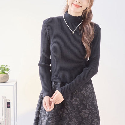 Mikonosublue Storeの黒いリブニットと花柄ふくれジャガードスカートをドッキングした長袖モックネックワンピース