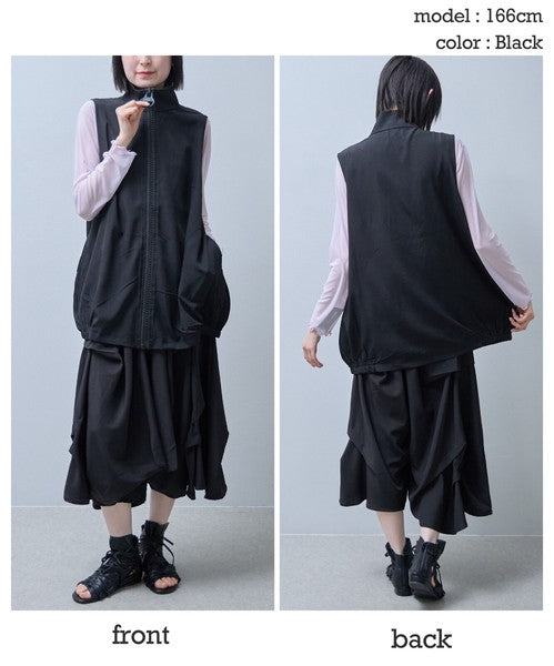 Mikonosublue Storeの黒いロングジレ。大きなリングジップと丸ポケットが特徴で、コクーンシルエットが体型をカバーする軽量なポリスパン素材のベスト。