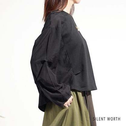 Mikonosublue Store black pullover with voluminous pleated raglan sleeves and mixed fabric design on a model
