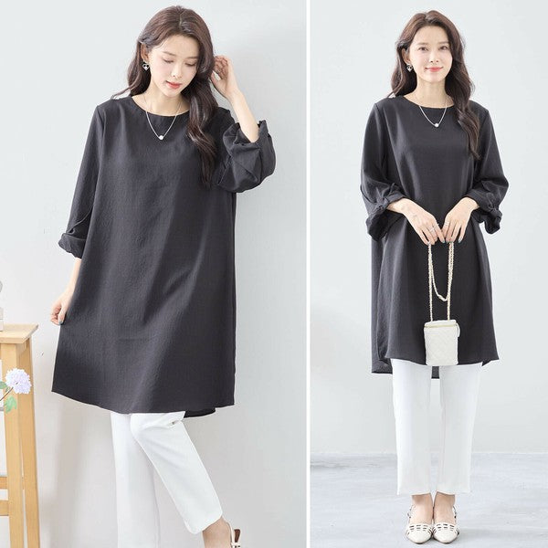 Mikonosublue Storeの袖口リボンが可愛い黒のAラインチュニックワンピース。ゆったりとしたシルエットで体型カバーも叶う七分袖の大人カジュアルスタイル。
