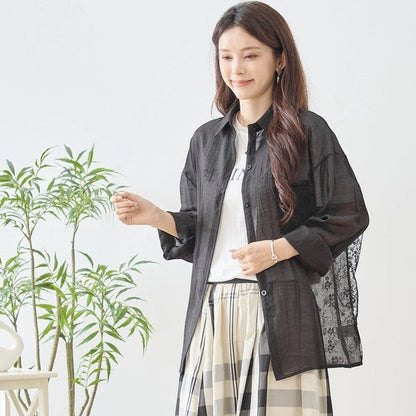 Mikonosublue Store black sheer long-sleeve blouse with floral lace paneling and button front.