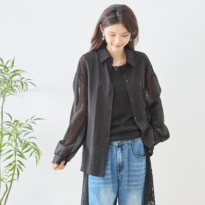Mikonosublue Store black sheer long-sleeve shirt with floral lace panels and a relaxed fit.