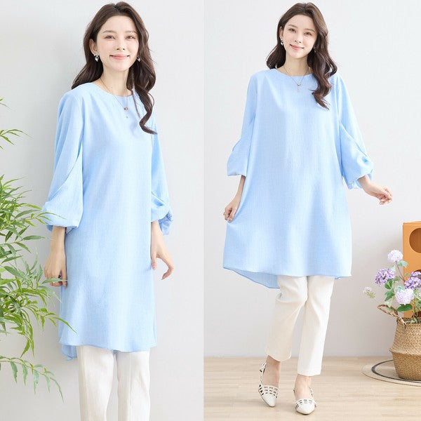 Mikonosublue Storeの袖口リボンが可愛い水色のAラインチュニックワンピース。ゆったりとしたシルエットで体型カバーも叶う春夏向けの一着。