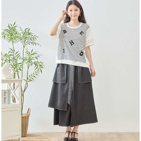 Mikonosublue Storeのアルファベット刺繍入りボーダー切り替えTシャツを着用した女性。ゆったりとしたシルエットで体型カバーも叶うカジュアルな半袖トップス。