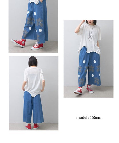 Mikonosublue Storeのフラワーとドット柄がプリントされた涼しげなブルーのワイドパンツを着用したモデル