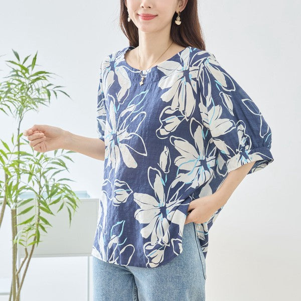 Mikonosublue Storeのネイビー地に白い大きな花柄が描かれた綿100%のゆったりとしたドルマン袖トップス