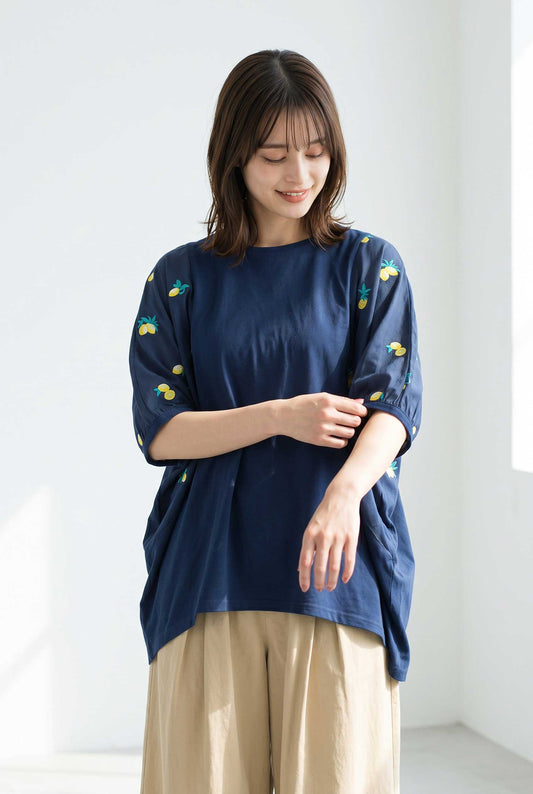 Mikonosublue Storeのネイビーの異素材切替Tシャツ。袖にレモンの刺繍が施された五分袖のビッグシルエットで、女性が着用している様子。
