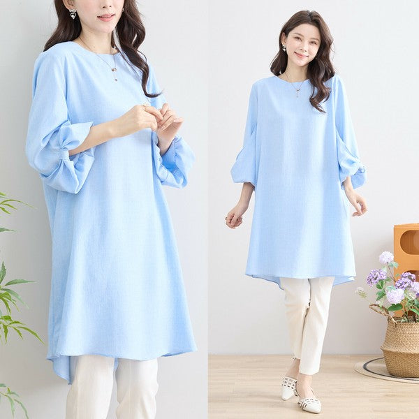 Mikonosublue Storeの袖口リボンが可愛い水色のAラインチュニックワンピース。ゆったりとしたシルエットで体型カバーも叶う春夏向けの一着。