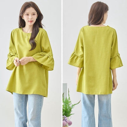 Mikonosublue Storeの袖リボン付きライムグリーン色Aラインチュニック。七分袖でゆったりとしたシルエットのきれいめブラウス。