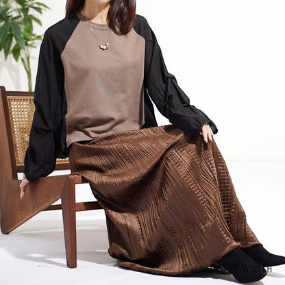 Mikonosublue Store pullover with brown body and black raglan tuck sleeves, paired with a pleated brown skirt.