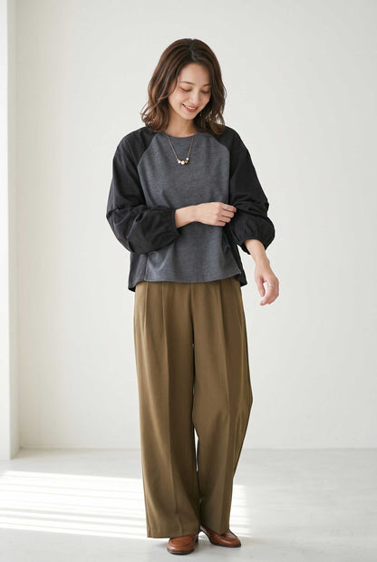 Mikonosublue Store grey and black mixed-material pullover with voluminous raglan tuck sleeves worn with brown trousers