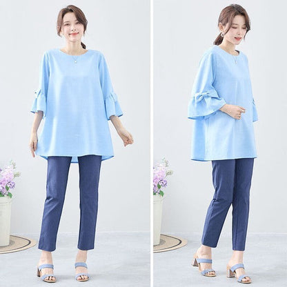 Mikonosublue Storeの袖リボン付き水色Aラインチュニック。七分袖でゆったりとしたシルエットのきれいめブラウス。