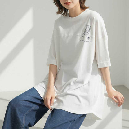 Mikonosublue Storeの猫プリントが可愛い白の綿100%チュニックTシャツ。ゆったりとしたドロップショルダーで前後差のある裾が特徴。