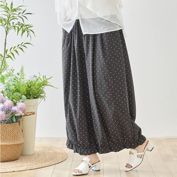 Mikonosublue Storeのピンドット柄ワイドパンツ。裾のギャザーフリルが特徴的な、ゆったりとしたポリエステル素材のネイビー系ボトムス。