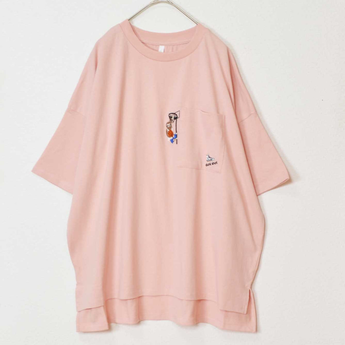 Mikonosublue Storeのピンク色の綿100%半袖Tシャツ。胸ポケットにバスケットボールをする動物の刺繍入り、ゆったりとしたドロップショルダーのボックスシルエット。