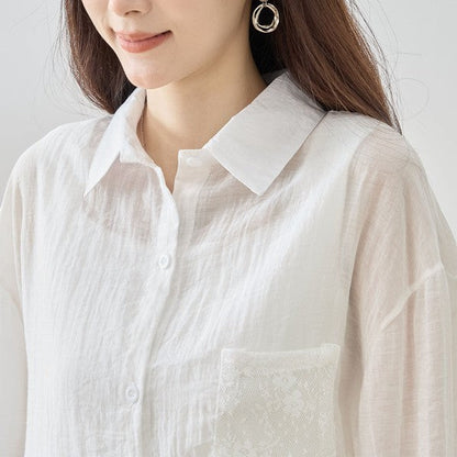 Mikonosublue Store white sheer long-sleeve blouse with floral lace pocket detail and relaxed fit.